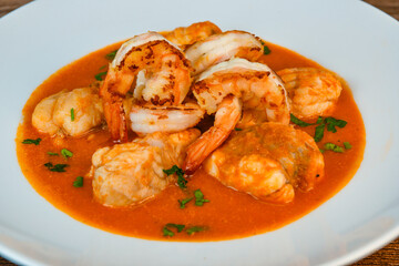 Recipe for Armorican-style monkfish tail, prawns, flambees with cognac, High quality photo