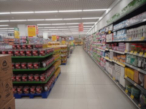 A supermarket aisle with shelves of merchandise photographed with a blurry 