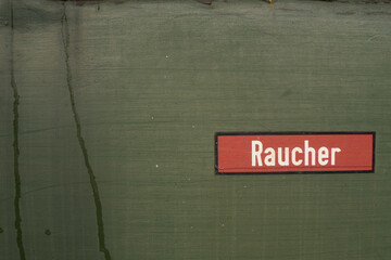 German sign smoking in german called Raucher at green background from train
