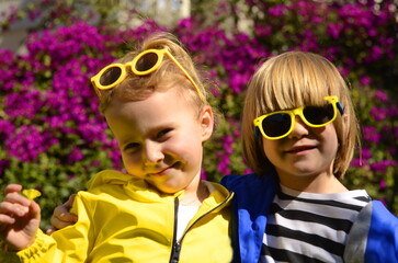 Boy and girl in bright jackets. Brother and sister, first love, kindergarten. Children's hugs