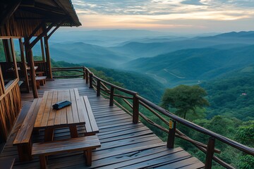 Wooden deck with benches overlooks serene mountain range at sunrise, sky painted in soft hues....