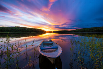 Beautiful sunset with a boat by a Swedish lake