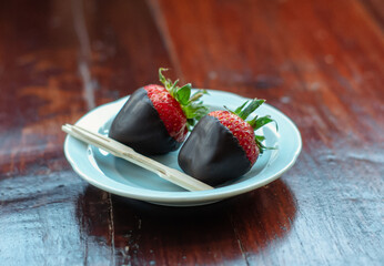 berry ripe strawberries in chocolate on a wooden background.