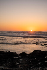 Fotografía vertical, Sol a punto de esconderse por el horizonte en Océano Atlántico, Fuerteventura, Islas Canarias
