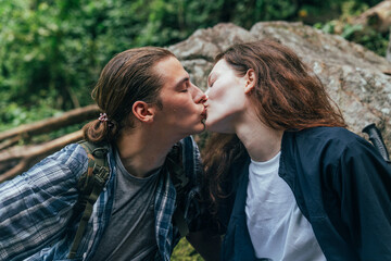 Fototapeta premium The happy couple is hiking in the forest. going on a camping trip. Man and woman backpackers lover concept.