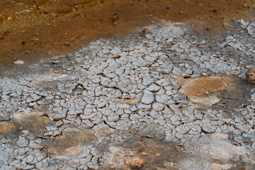 Dirt inHot springs in Hverir - Namafjall Geothermal Area in Iceland.Boiling mudpots in the geothermal area Hverir. Northeastern region, Krafla volcano, Iceland, Europe. Image of exotic world landmark.