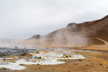 Hot springs in Hverir - Namafjall Geothermal Area in Iceland.Boiling mudpots in the geothermal area Hverir. Northeastern region, Krafla volcano, Iceland, Europe. Image of exotic world landmark.