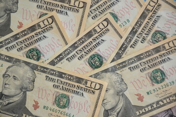Obraz na płótnie Canvas A Pile of Ten Dollar Bills as a Money Background