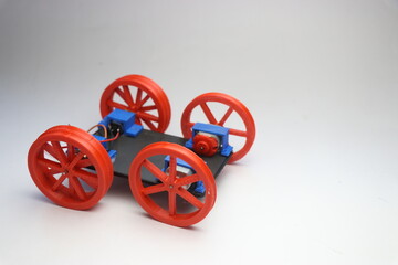 Model of an assembled wheel movement for a robotic car on a white background. Building electronic hobby projects concept