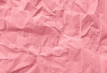 close up texture of pink crumpled or torn old craft paper use as background with blank space for...