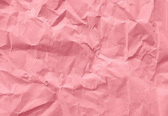 Fototapeta premium close up texture of pink crumpled or torn old craft paper use as background with blank space for design. creased recycle pink craft paper texture for valentines concept.