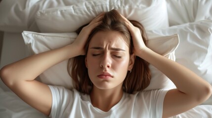 Fototapeta premium A sleepless man suffers from insomnia, sleep apnea, or stress. Tired and exhausted guy. Headache or migraine. Awake in the night. A frustrated person with problem Tired and exhausted guy.