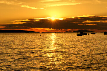Gold color tone sunset in small rural port on the sea coast