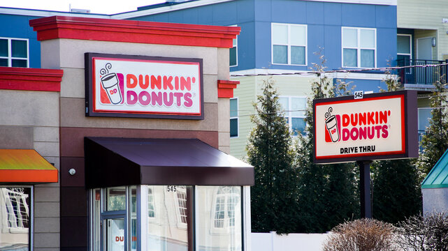 NORWALK, CT, USA - FEBRUARY 9, 2024:   Dunkin Donut' coffee shop building near Post road in Norwalk in nice sunny winter day