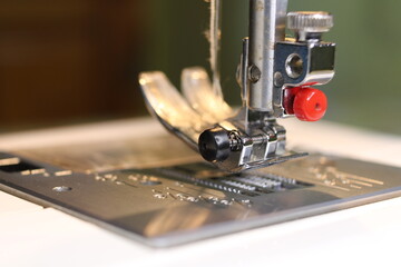 Sewing machine close up - needle, needle plate and foot.