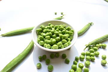 Fresh green pea on white background. There is a lot of vitamins  and Minerals in it. The pea is most commonly the small spherical seed or the seed. Popular vegetable of all over world. 