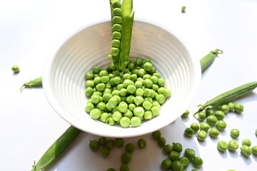Fresh green pea on white background. There is a lot of vitamins  and Minerals in it. The pea is...