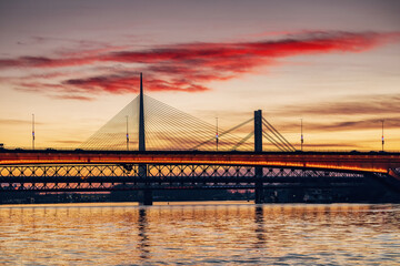 magnificent sunset over the Sava River in Belgrade, Serbia, illuminating Bridge and surrounding urban landscape with a golden glow.