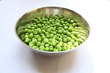 Fresh green pea on white background. There is a lot of vitamins  and Minerals in it. The pea is most commonly the small spherical seed or the seed. Popular vegetable of all over world. 