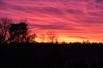 Magical sunset in winter in January over Bredebolet in Skaraborg in Vaestra Goetaland in Sweden