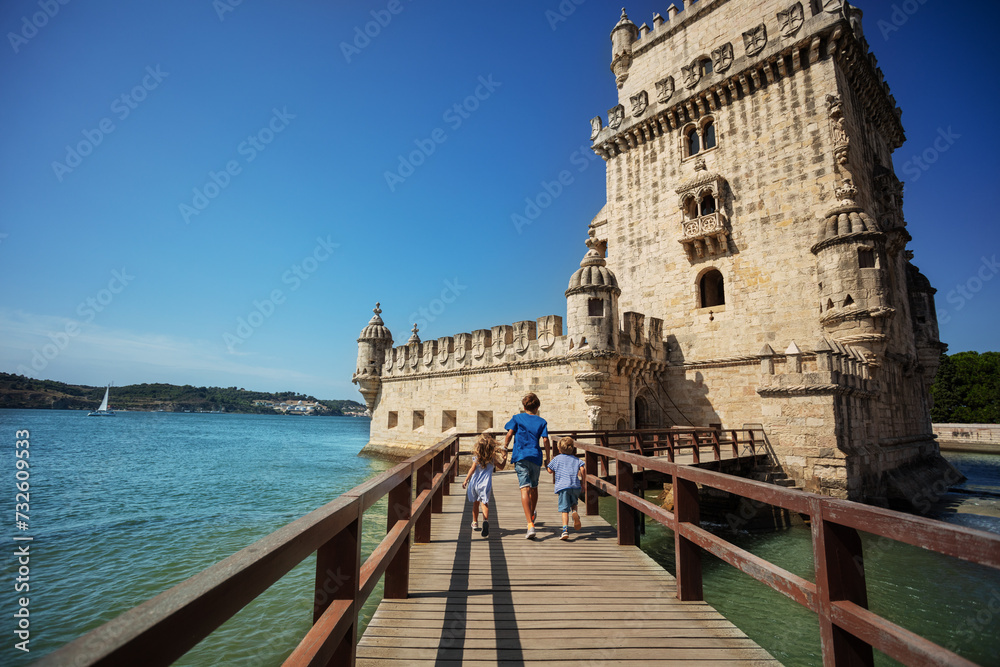 Wall mural group of kids travelers excited to visit famous tower belem