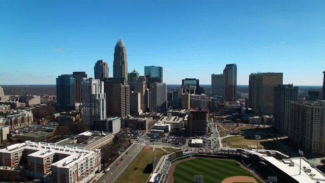 Aerial Shot Of Truist Field In Modern Residential City Against Clear Sky, Drone Flying Backwards On Sunny Day - Charlotte, North Carolina