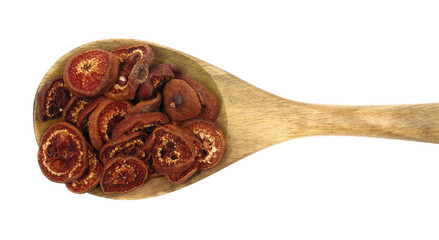 Wild dried pears slices in wooden spoon, isolated on white