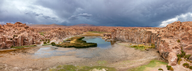 Laguna Catal, a stunning lake surrounded by eroded lava boulders, populated by herds of semi-wild...