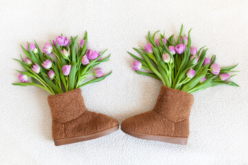 Brown boots full of flowers. Purple peony tulips. Spring mood, stylish shoes, fashion, sale, womens day concept. Double price early tulip. Selective soft focus.