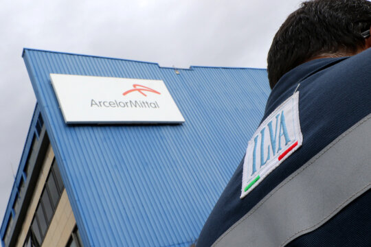 Workers in overalls from the Ilva steel industry, now ArcelorMittal. Taranto Puglia, Italy