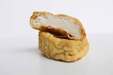 Fried yellow tofu sliced, isolated on white background