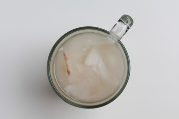 Beverage made from chilled or iced coconut water and young coconut flesh, isolated on white background, flat lay or top view