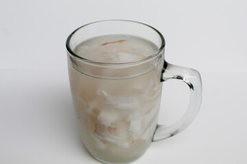 Beverage made from chilled or iced coconut water and young coconut flesh, isolated on white background