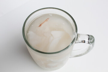 Beverage made from chilled or iced coconut water and young coconut flesh, isolated on white background
