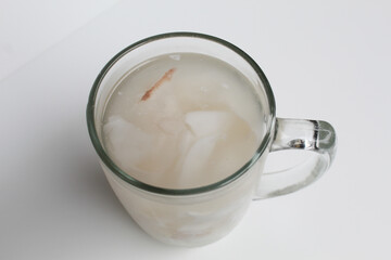 Beverage made from chilled or iced coconut water and young coconut flesh, isolated on white background