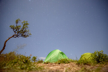 Capture the essence of adventure and tranquility in a striking landscape photo showcasing a camping...