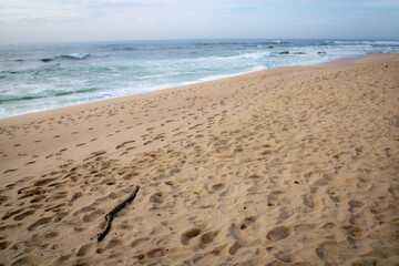 footprints on the sand over the sea