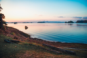Capture the essence of adventure and tranquility in a striking landscape photo showcasing a camping setup amidst the majestic mountain ranges of Khao San Nok Wua and Pom Pee  , Thailand. 