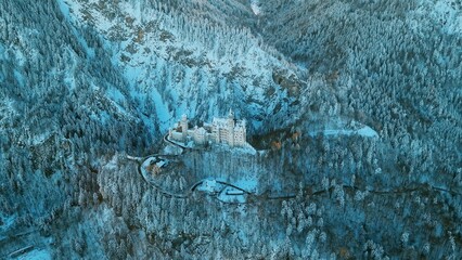 Aerial panorama of royal castle Neuschwanstein in Bavaria, Germany (Deutschland). The famous Bavarian place sign at winter morning.