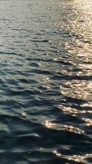 Sunrise reflection on the surface deep blue sea .