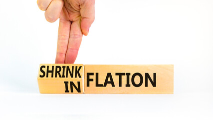 Inflation or shrinkflation symbol. Concept words Inflation Shrinkflation on beautiful wooden blocks. Beautiful white background. Businessman hand. Business inflation shrinkflation concept. Copy space