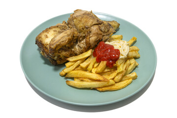 Roasted chicken with French fries, topped with ketchup and mayonnaise, served on a turquoise plate. Isolated on a white background.