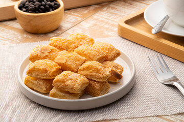 Almond crispy pie on white plate.crisp bread with sliced almond and sugar