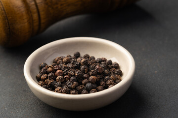 fragrant spices ,black peppercorn in white bowl background