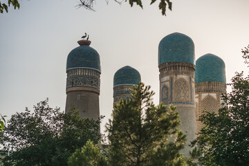 Exterior of Chor Minor Madrasah in the ancient city of Bukhara in Uzbekistan, oriental architecture at sunset in the evening - obrazy, fototapety, plakaty