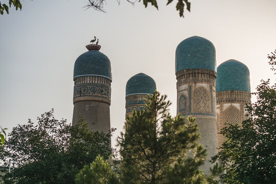 Exterior of Chor Minor Madrasah in the ancient city of Bukhara in Uzbekistan, oriental architecture at sunset in the evening