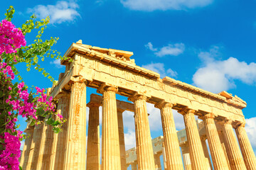 Parthenon temple, Acropolis hill, Athens Greece over beautiful blue sky and flowers