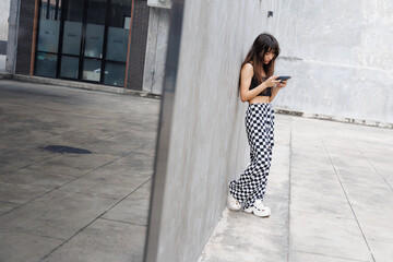 Girl playing on mobile phone, watching video clip or browsing online.