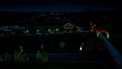Twilight Scenery With Illuminated Christmas Decorations, Row Of Trees Wrapped In Lights, And A Lit...