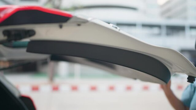 Close-up of a car tailgate or closing a car door with a woman's hand Concept of car health check